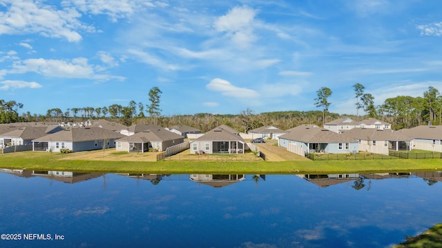 birds eye view of property with a residential view and a water view