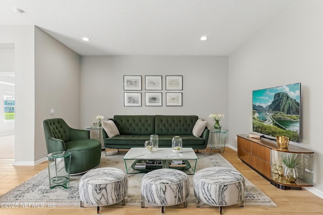 living area with recessed lighting, baseboards, and light wood-style floors