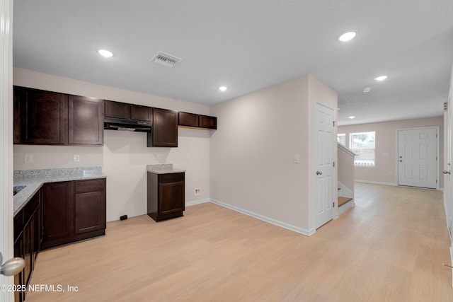 kitchen featuring recessed lighting, visible vents, dark brown cabinets, and light wood-style flooring