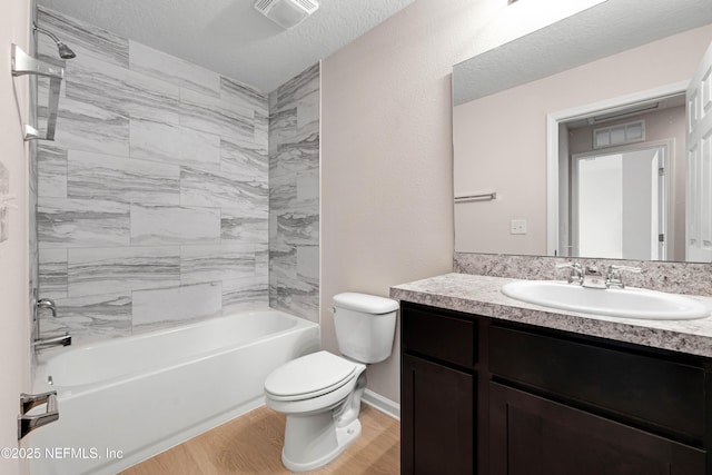 bathroom featuring vanity, wood finished floors, visible vents, toilet, and shower / bathtub combination