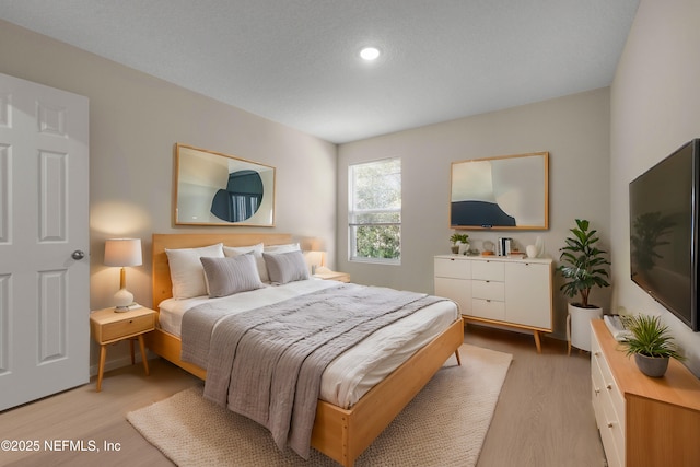 bedroom featuring light wood-style floors