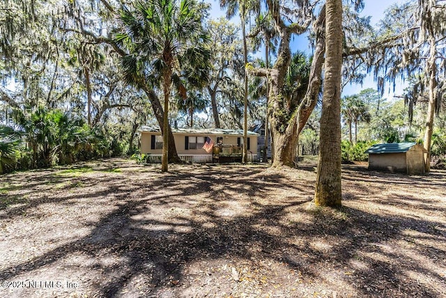 19040 Waterville Rd, Jacksonville, FL 32226 - view of yard with a storage unit and an outdoor structure