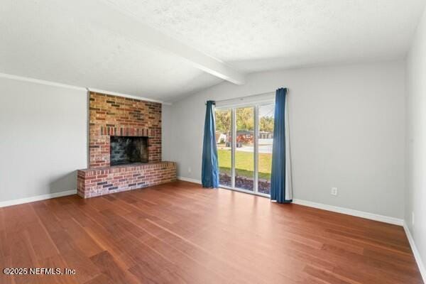 unfurnished living room with lofted ceiling with beams, baseboards, and wood finished floors