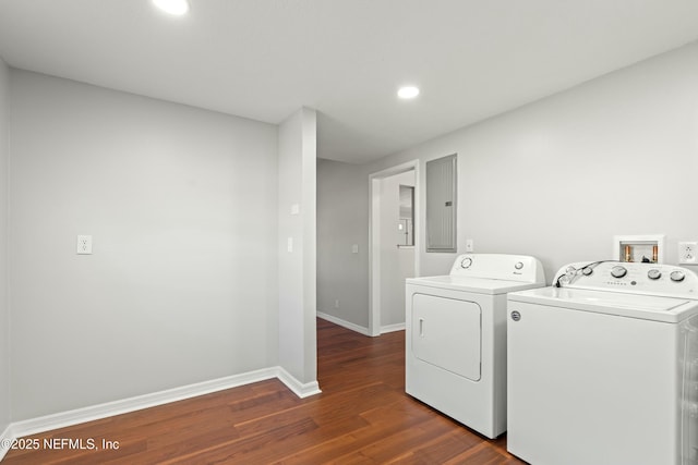 laundry room featuring dark wood finished floors, laundry area, washing machine and dryer, and baseboards