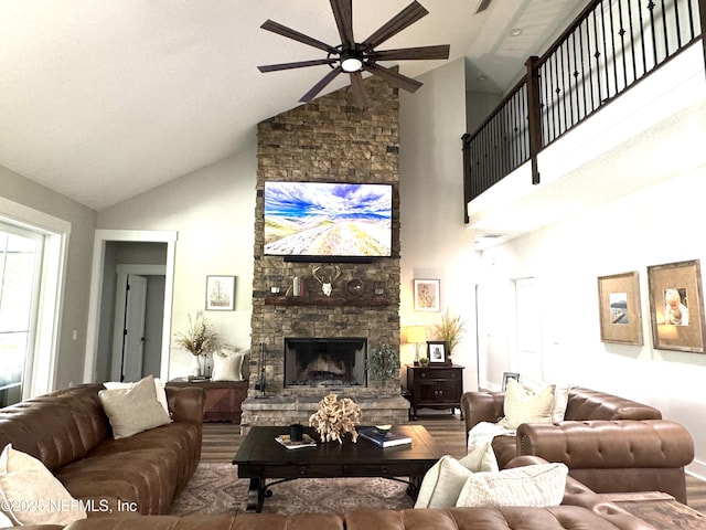 living room with a stone fireplace and ceiling fan