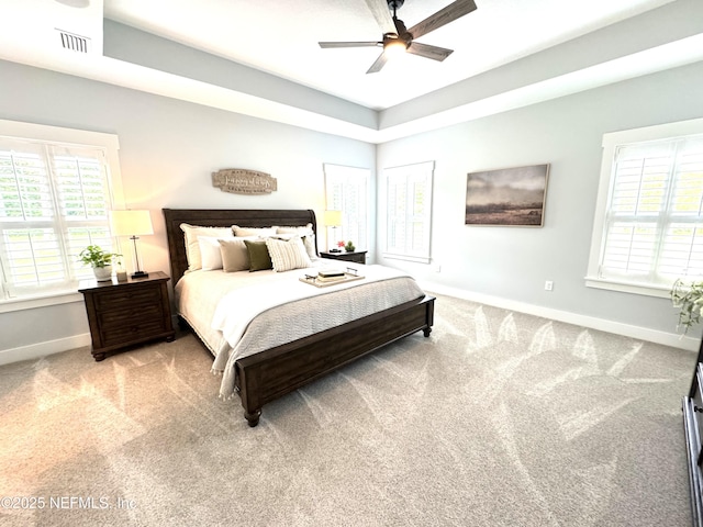 carpeted bedroom with baseboards, multiple windows, and ceiling fan