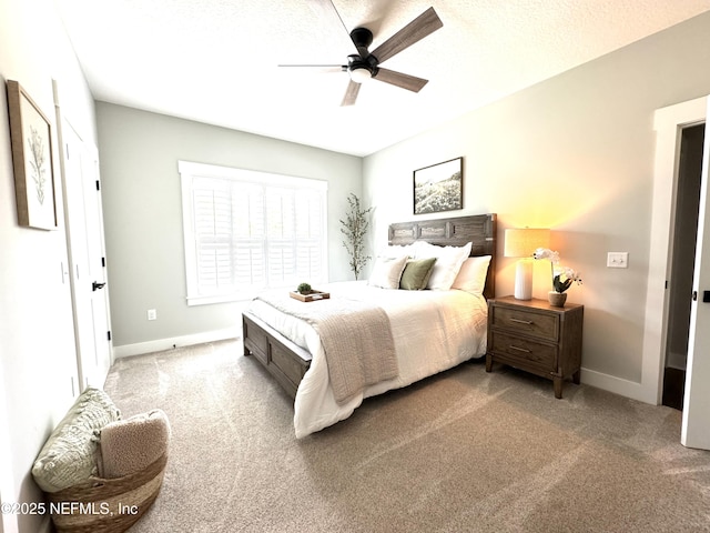bedroom with ceiling fan, baseboards, and carpet floors