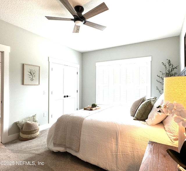 carpeted bedroom with a closet and a ceiling fan