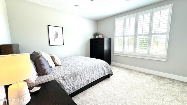 bedroom with carpet flooring and baseboards