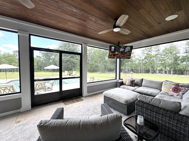 sunroom featuring an outdoor living space and ceiling fan