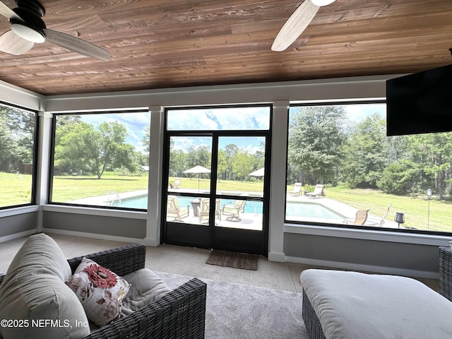 sunroom / solarium featuring ceiling fan