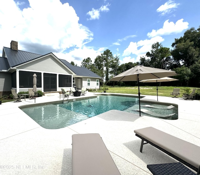 pool with a patio area, a yard, and a sunroom