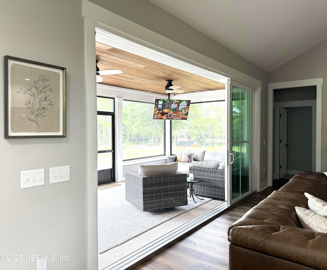 doorway with a healthy amount of sunlight, ceiling fan, lofted ceiling, and wood finished floors