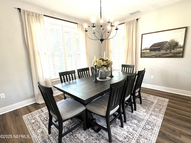 dining room with visible vents, baseboards, dark wood-type flooring, and a chandelier