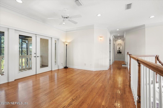 unfurnished room featuring visible vents, light wood-style flooring, a ceiling fan, and french doors
