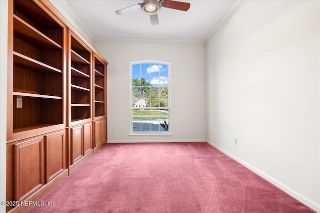 carpeted spare room featuring baseboards, crown molding, and ceiling fan