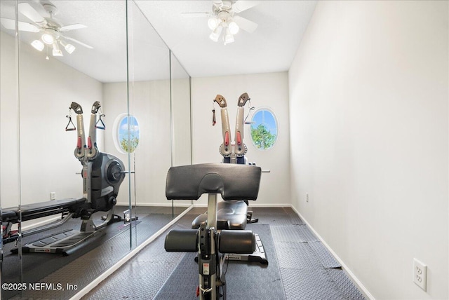 workout room with baseboards and ceiling fan