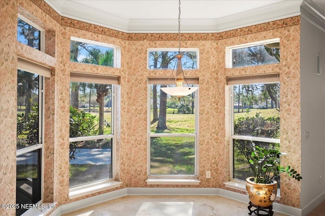 unfurnished sunroom with a wealth of natural light, baseboards, and ornamental molding