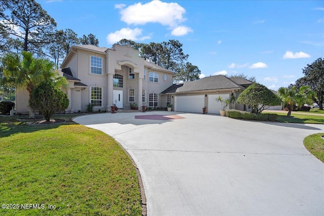 view of front of property featuring stucco siding, an attached garage, driveway, and a front lawn