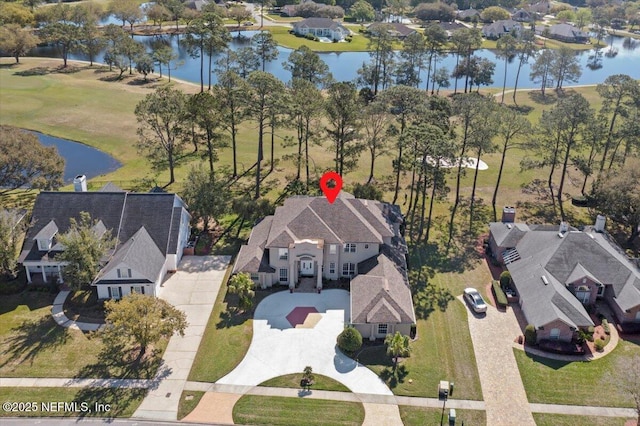 drone / aerial view with a water view and a residential view