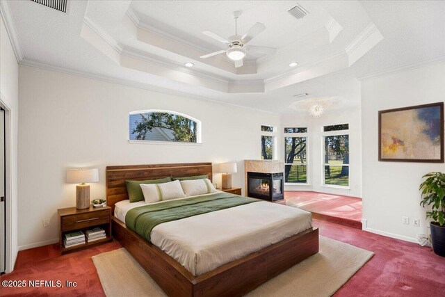 bedroom featuring a raised ceiling, baseboards, and visible vents