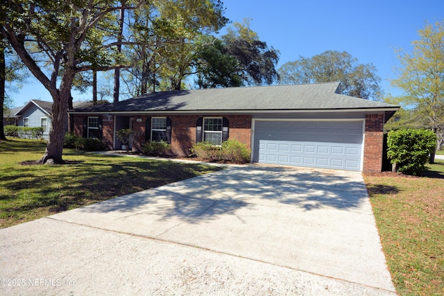 ranch-style home featuring a front yard, an attached garage, brick siding, and concrete driveway