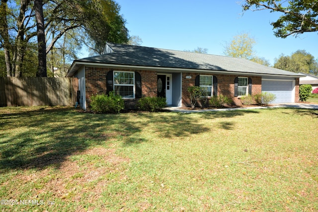 ranch-style home with a garage, brick siding, fence, and a front lawn