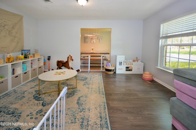 playroom featuring wood finished floors and baseboards