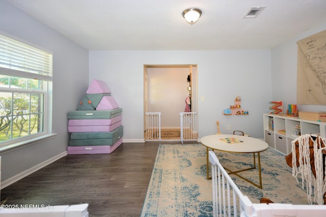 playroom with visible vents, baseboards, and wood finished floors