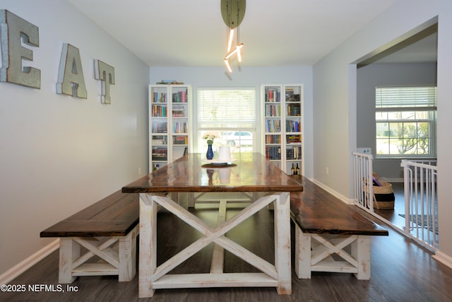dining area featuring a healthy amount of sunlight, wood finished floors, and baseboards