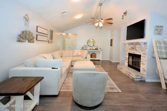 living room featuring visible vents, a stone fireplace, a ceiling fan, dark wood finished floors, and vaulted ceiling