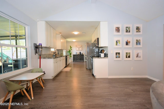 kitchen featuring appliances with stainless steel finishes, dark wood-style flooring, a sink, and white cabinetry