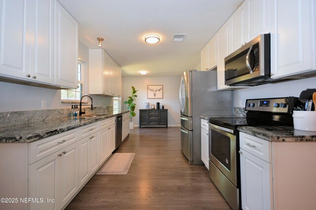 kitchen featuring a sink, visible vents, white cabinets, and appliances with stainless steel finishes
