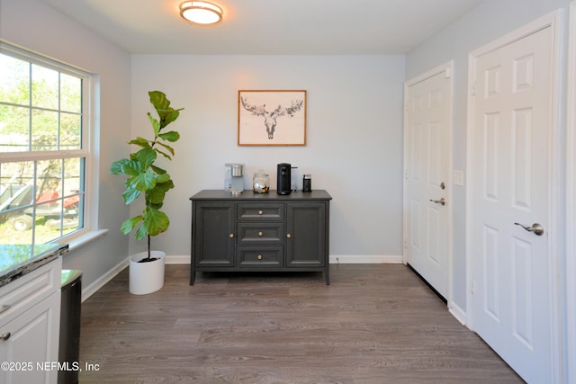 interior space with baseboards and wood finished floors