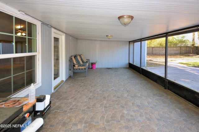 unfurnished sunroom with stone finish flooring