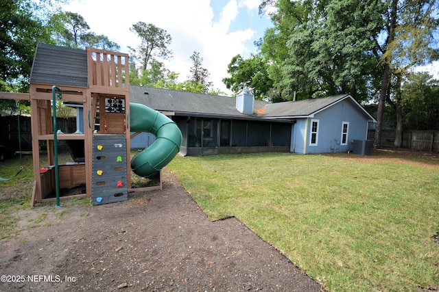 exterior space with a sunroom, cooling unit, fence, and a playground