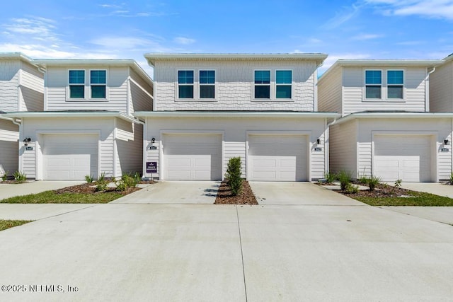 view of front of property with concrete driveway and an attached garage