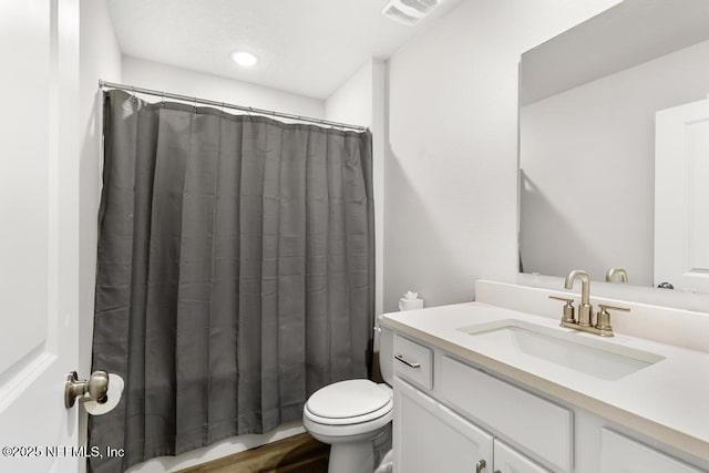 bathroom with visible vents, toilet, vanity, and a shower with curtain
