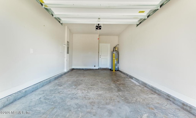 garage featuring baseboards and water heater