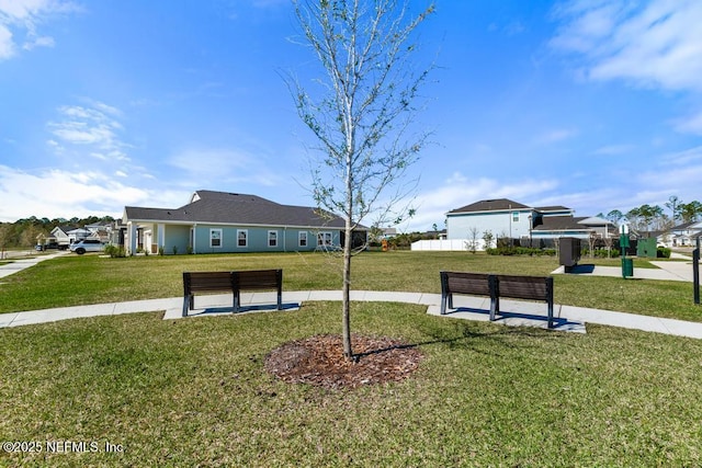 view of property's community featuring a lawn
