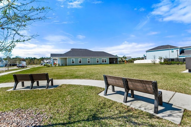 view of home's community featuring a lawn