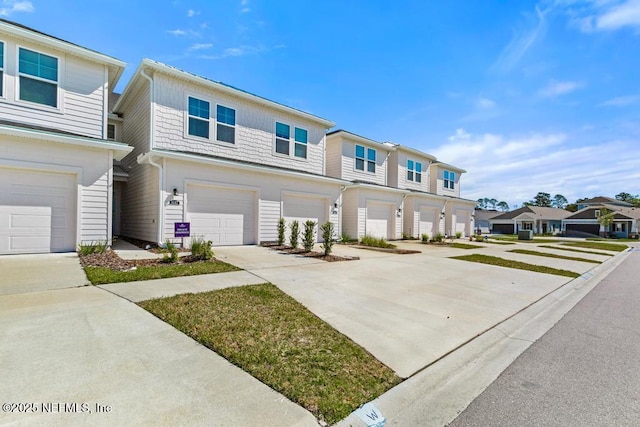 townhome / multi-family property featuring a residential view, driveway, and a garage