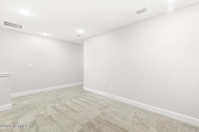 unfurnished room with visible vents, baseboards, and carpet floors