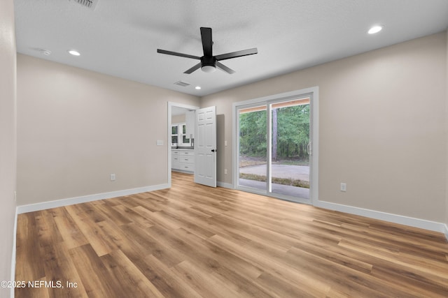 unfurnished room featuring recessed lighting, light wood finished floors, baseboards, visible vents, and a ceiling fan