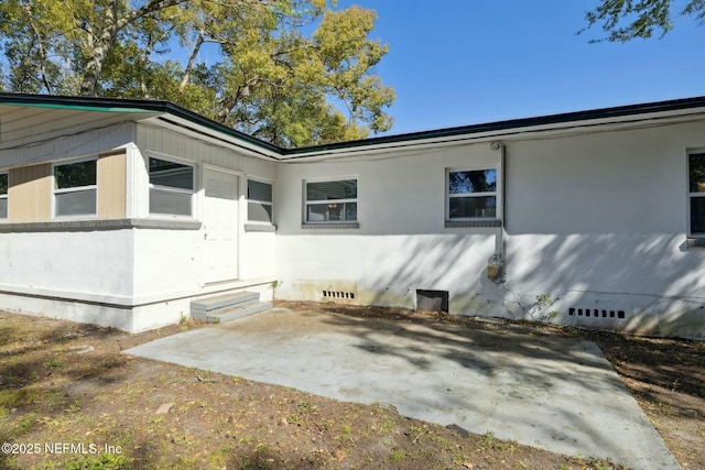 view of property exterior featuring crawl space, entry steps, and a patio area