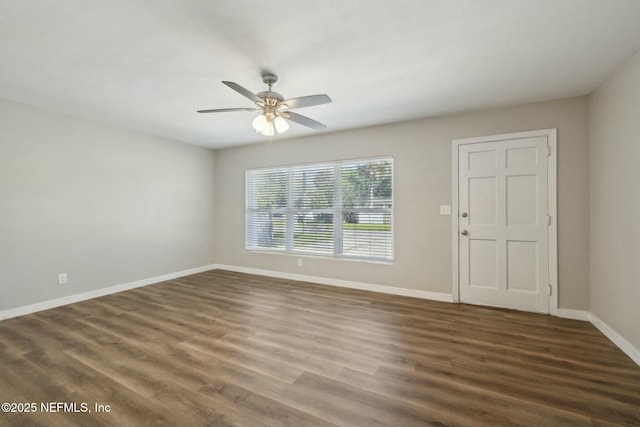 empty room featuring baseboards, wood finished floors, and a ceiling fan