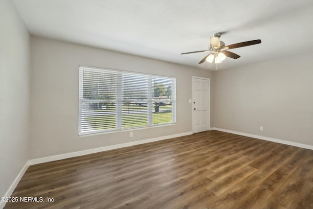 unfurnished room featuring baseboards, wood finished floors, and a ceiling fan