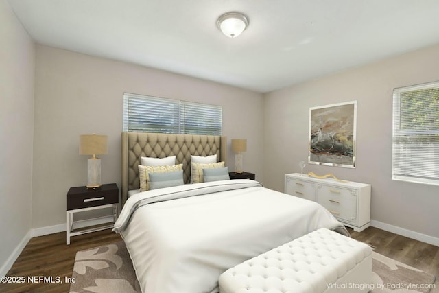 bedroom with baseboards and wood finished floors