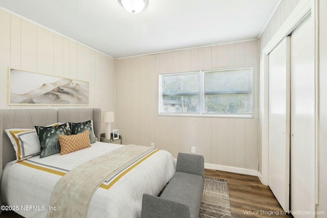 bedroom featuring baseboards, a closet, and wood finished floors