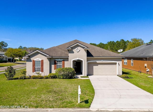 view of front of home featuring a front yard, an attached garage, driveway, and stucco siding